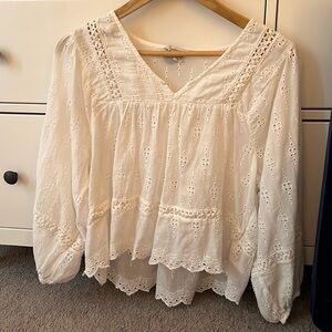 White, lightweight blouse. Sleeves puff and is a little see through.